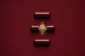 Anchor capsule anatomy, oxblood red shell with beige powder