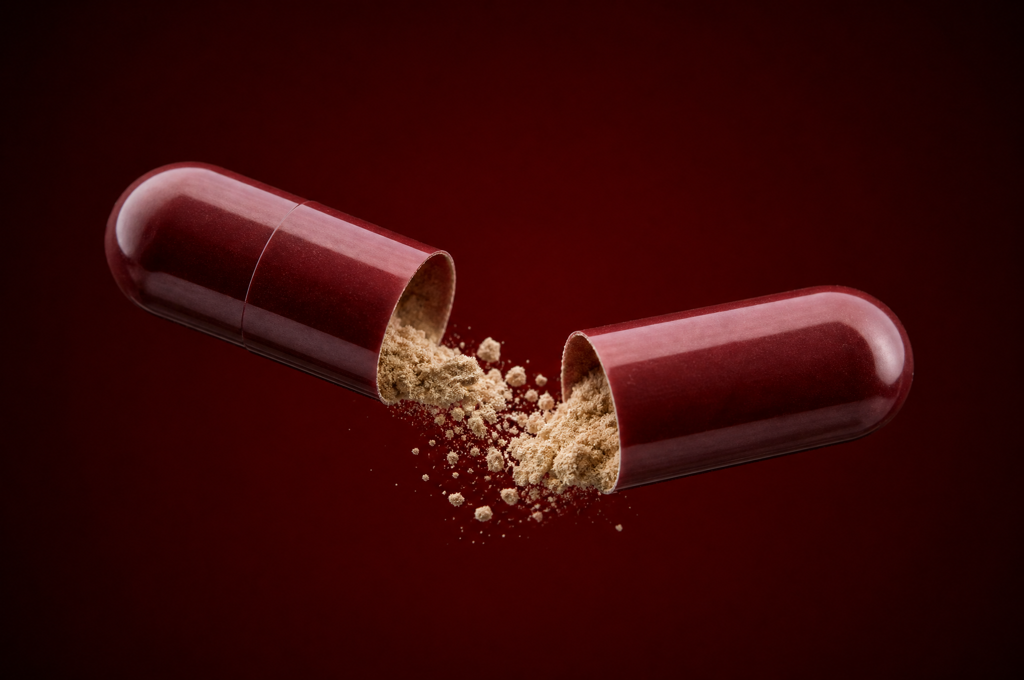 Anchor capsule pulled apart showing red shell and beige powder